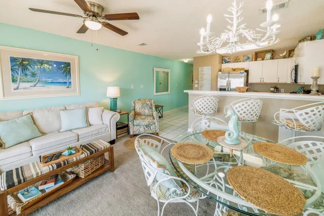 a living room with furniture and a dining table