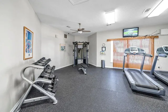 a view of a patio with chairs under an umbrella