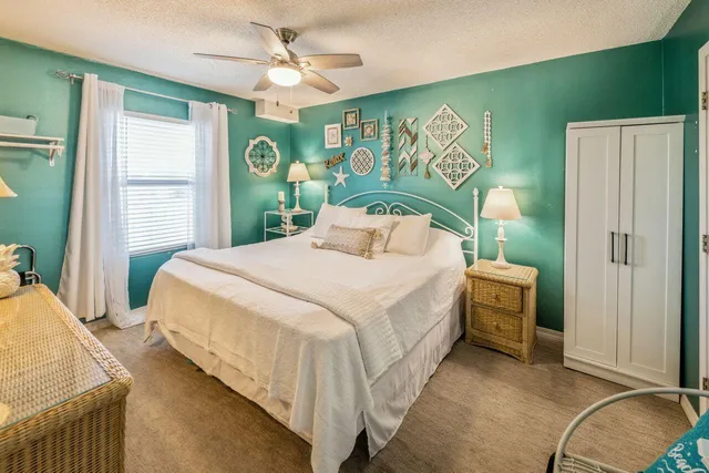 a bedroom with a bed dresser and a window