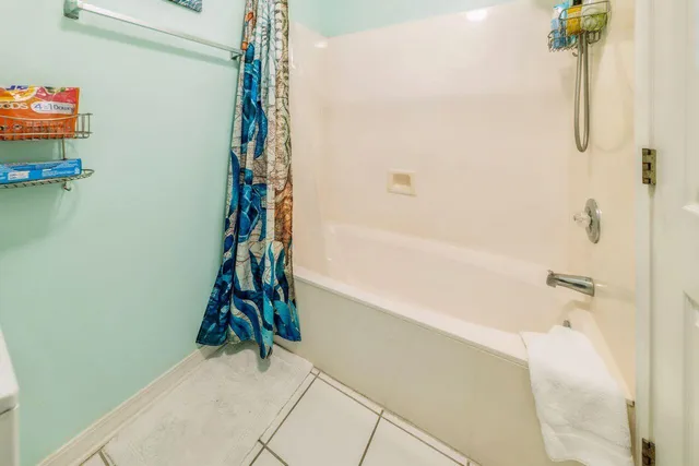 a bathroom with a shower and a bath tub