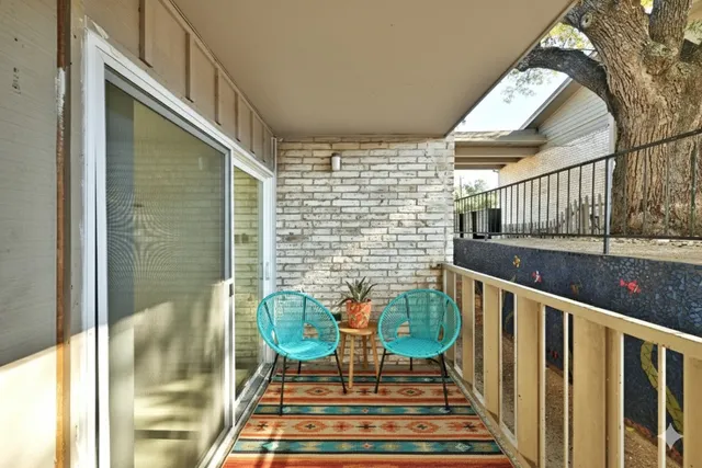a balcony view with couple of chairs