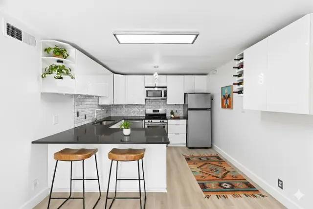 a kitchen with refrigerator and cabinets