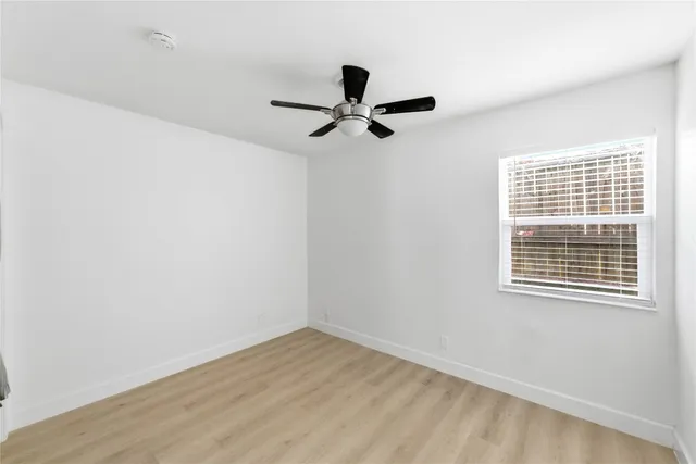 a view of empty room with ceiling fan