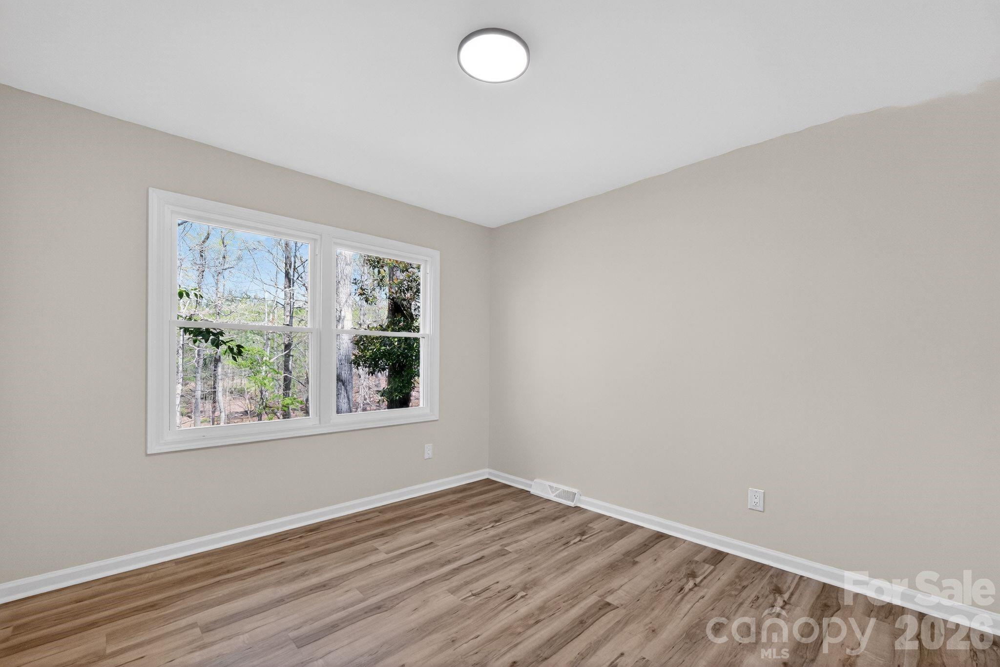 874 Red Fox Lane Concord, NC 28025 - Photo 11 of 17 an empty room with wooden floor and windows