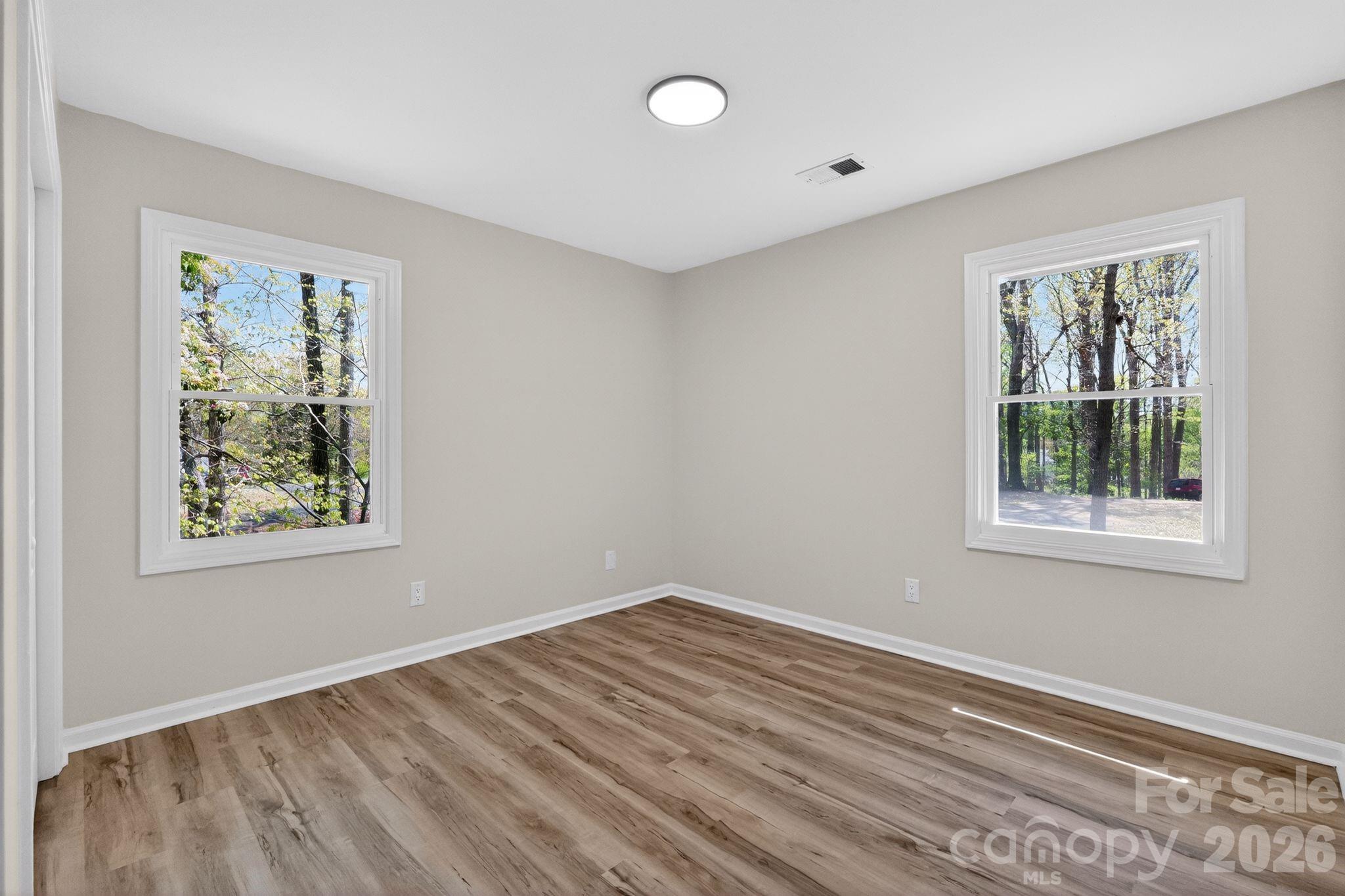 874 Red Fox Lane Concord, NC 28025 - Photo 14 of 17 a view of room with window and hardwood floor