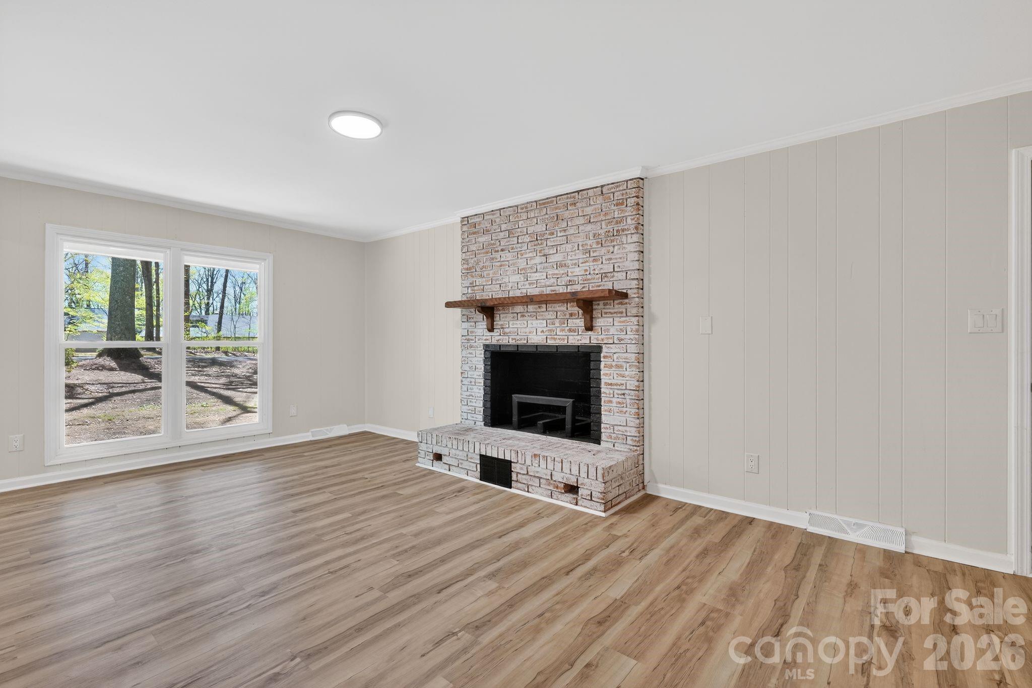 874 Red Fox Lane Concord, NC 28025 - Photo 5 of 17 a view of empty room with wooden floor and fan