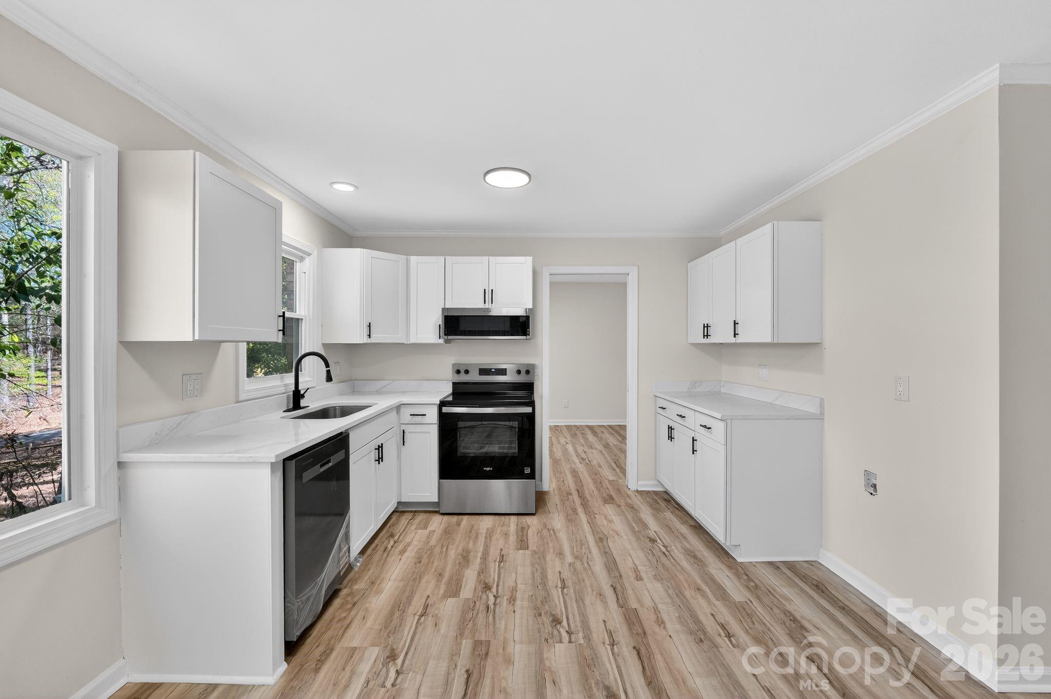 874 Red Fox Lane Concord, NC 28025 - Photo 6 of 17 a kitchen with granite countertop white cabinets and white appliances