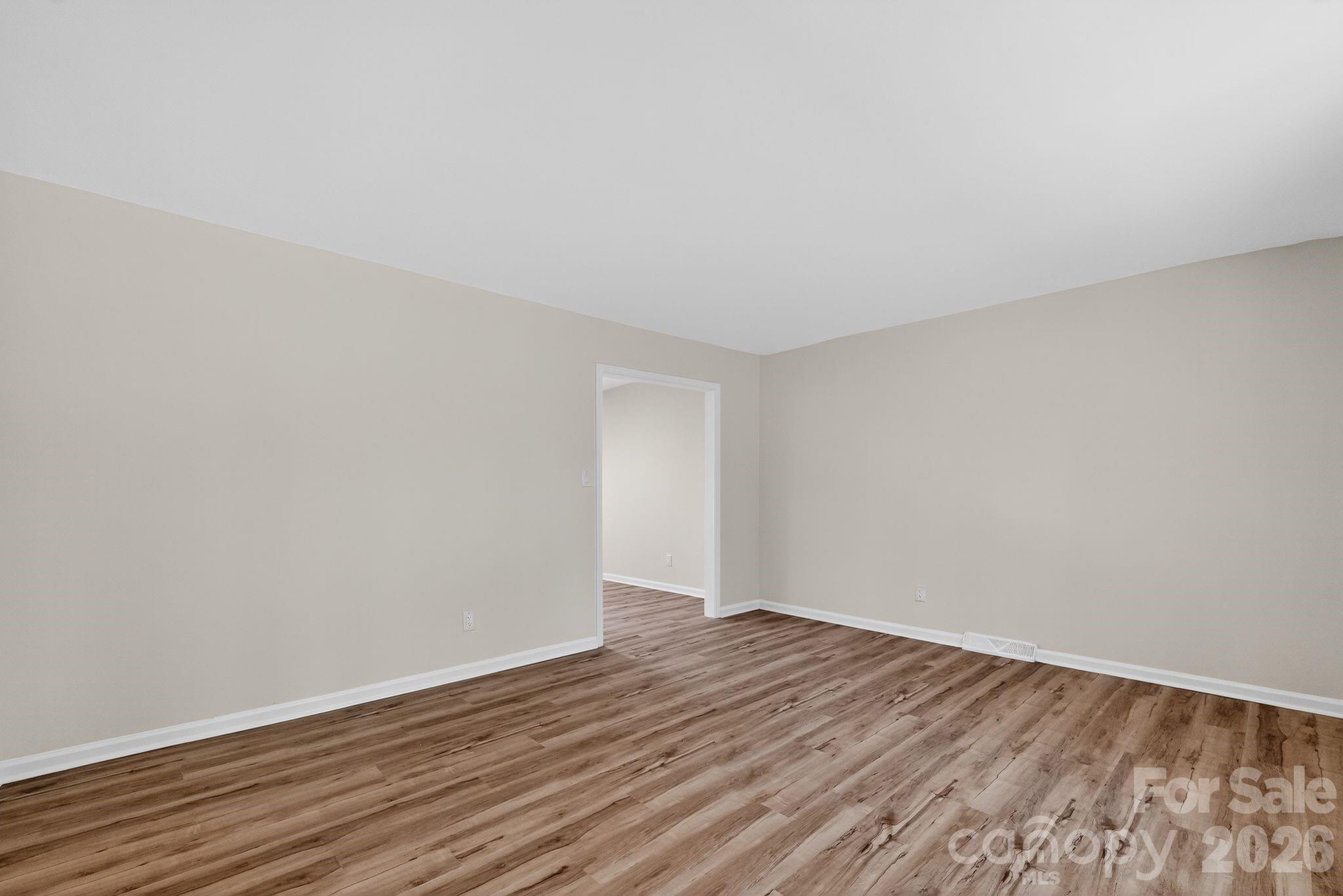 874 Red Fox Lane Concord, NC 28025 - Photo 7 of 17 a view of an empty room with wooden floor