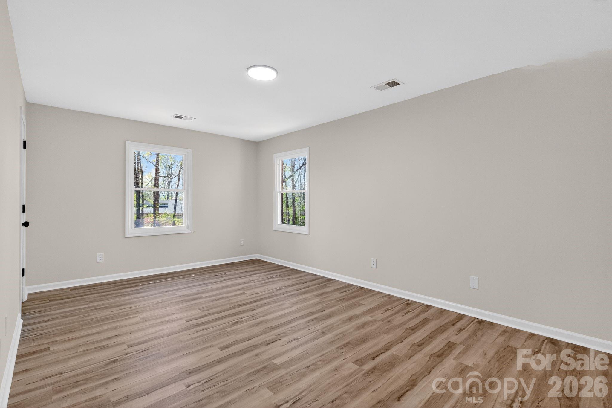 874 Red Fox Lane Concord, NC 28025 - Photo 8 of 17 wooden floor in an empty room with a window