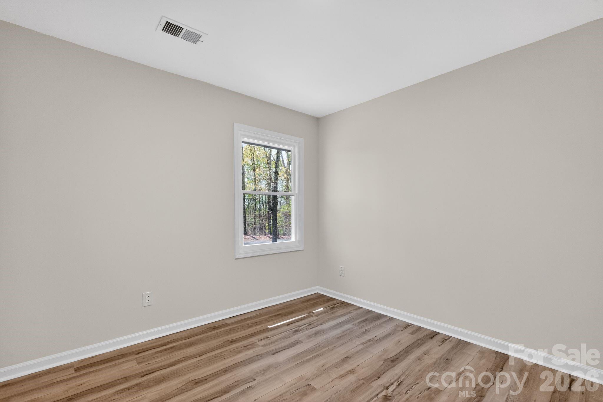 874 Red Fox Lane Concord, NC 28025 - Photo 9 of 17 an empty room with wooden floor and windows