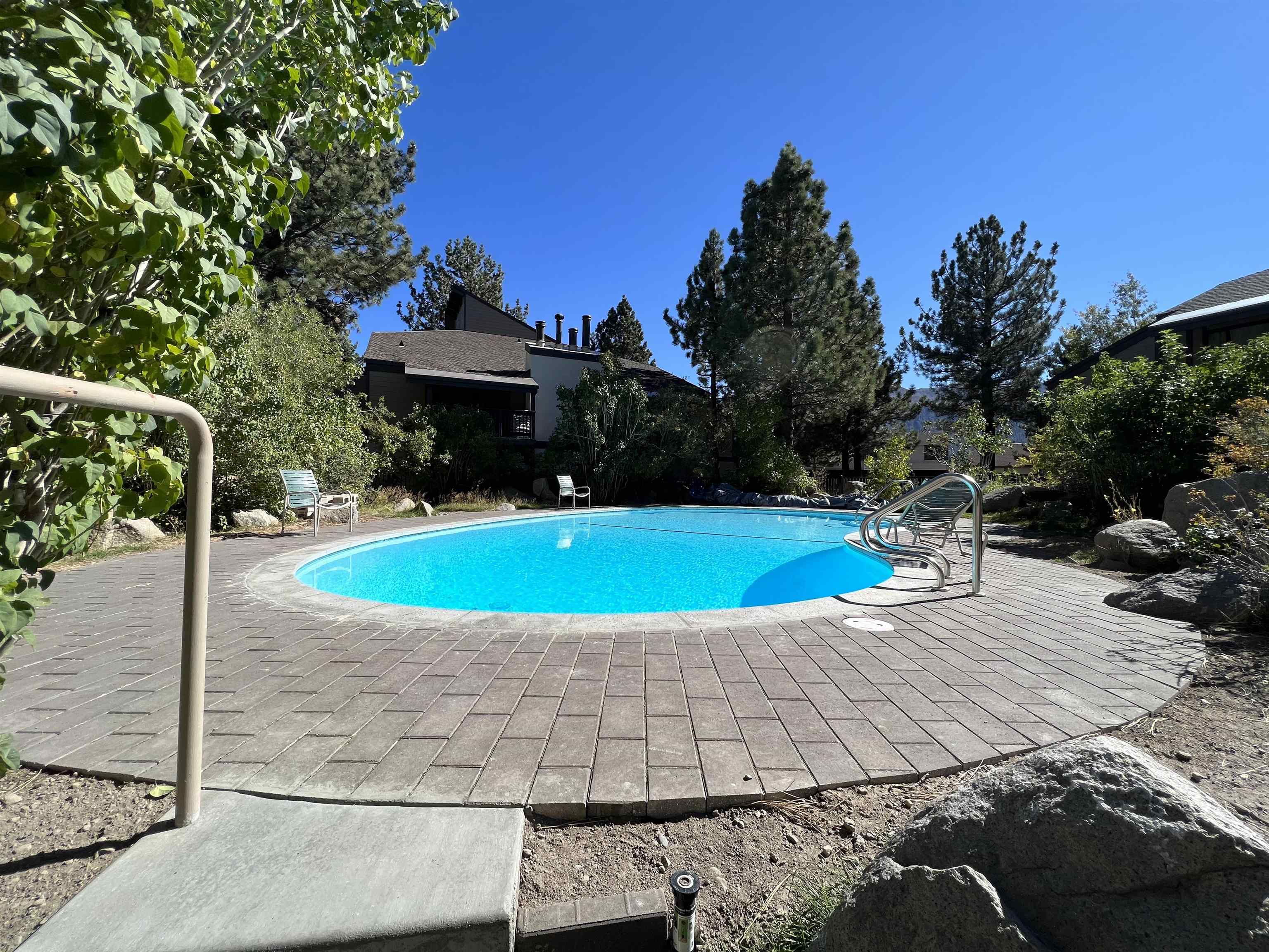 362 Old Mammoth Road, Unit 59 Mammoth Lakes, CA 93546 - Photo 29 of 35 Outdoor swimming pool with integrated entry steps and surrounding paver patio