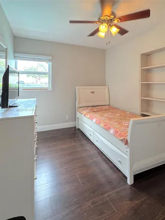 a room with a bed and a chandelier