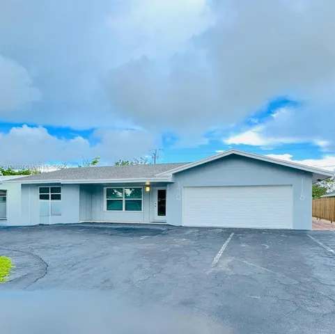 a view of a house with a backyard