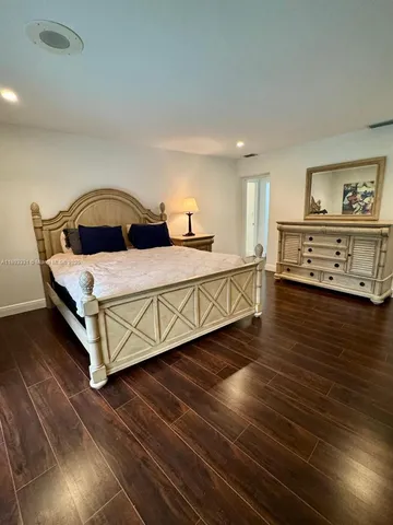 a living room with a bed furniture and a window