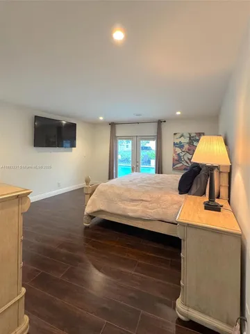 a room with a bed and a flat screen tv