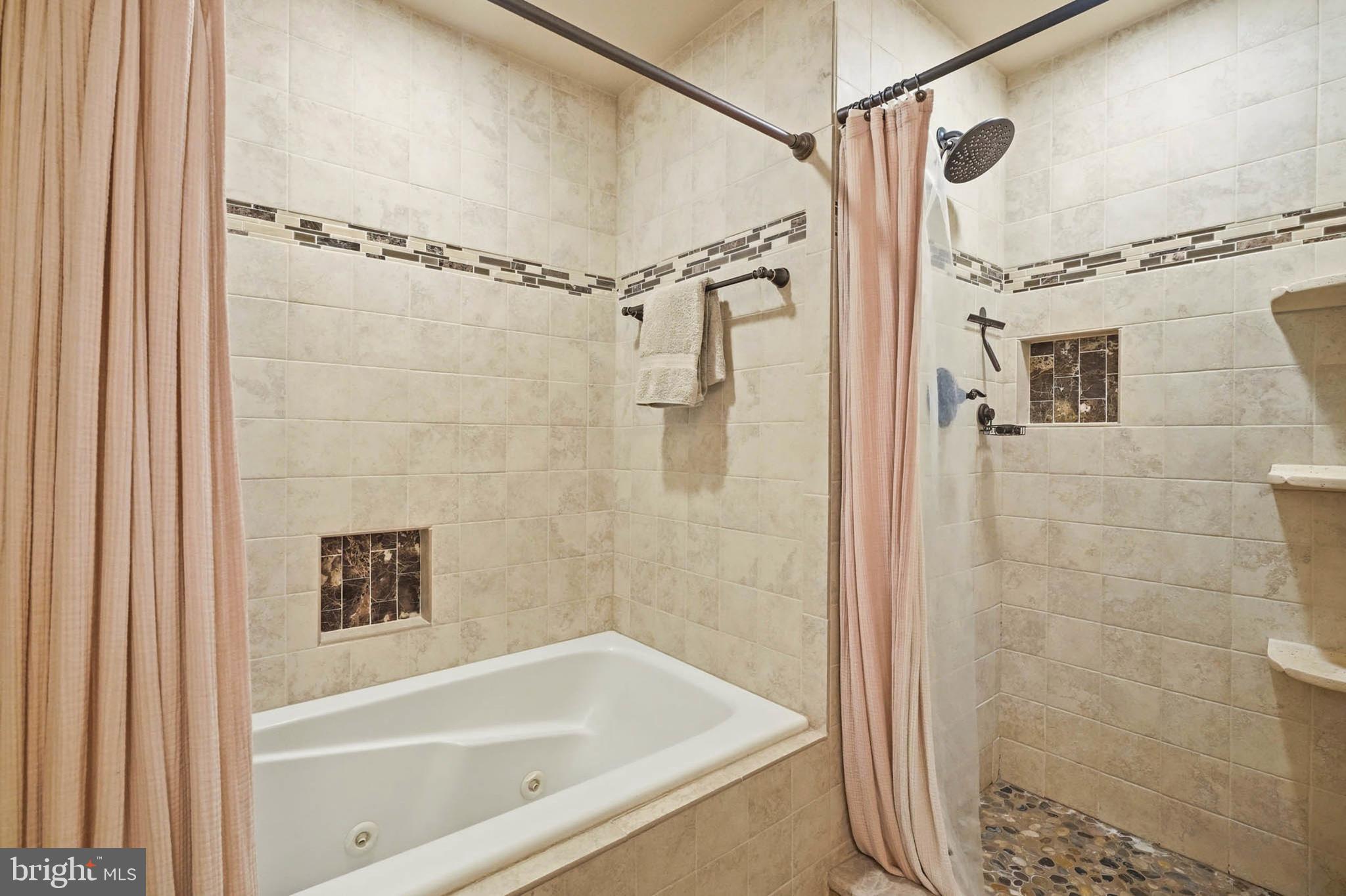 8721 Spring Brook Way Odenton, MD 21113 - Photo 26 of 40 a bathroom with a shower and a tub