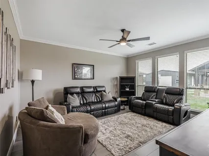 a living room with furniture ceiling fan and a rug