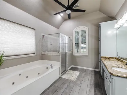 a bathroom with a bathtub and a shower
