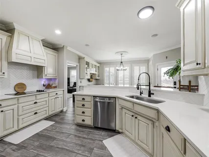 a kitchen that has white cabinets