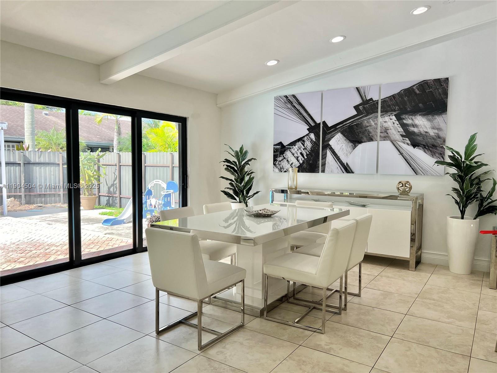 11104 Southwest 139th Court Miami, FL 33186 - Photo 14 of 56 a dining room with furniture and floor to ceiling windows