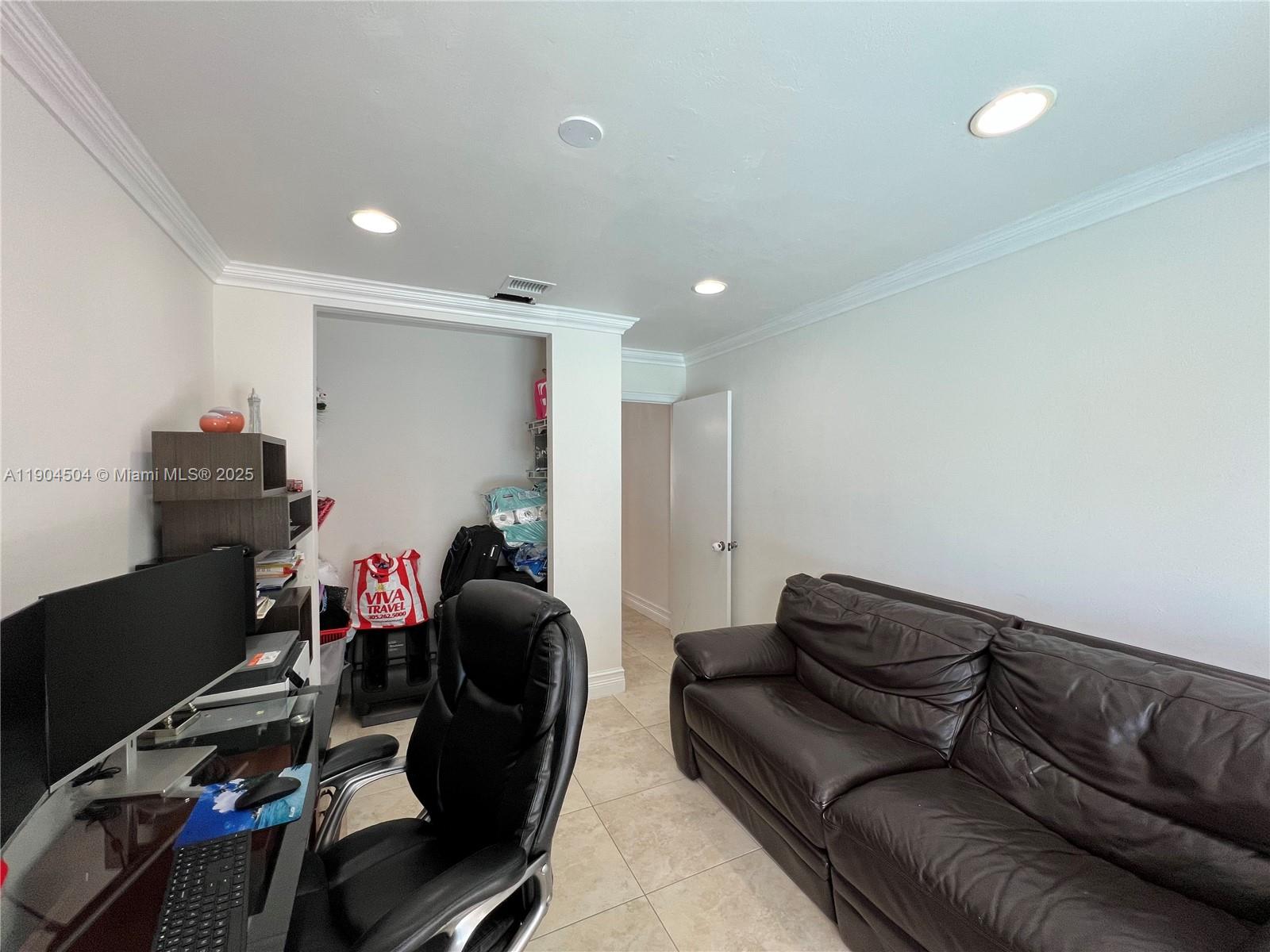 11104 Southwest 139th Court Miami, FL 33186 - Photo 40 of 56 a living room with furniture and a wooden floor
