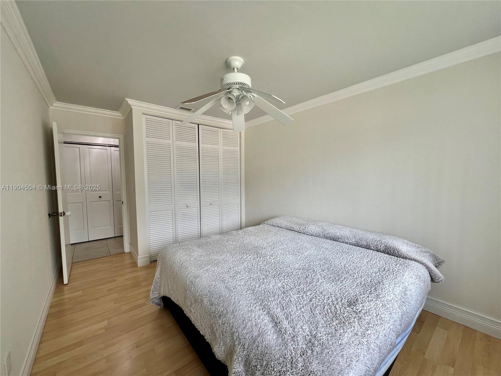 11104 Southwest 139th Court Miami, FL 33186 - Photo 48 of 56 a bedroom with a bed and a chandelier