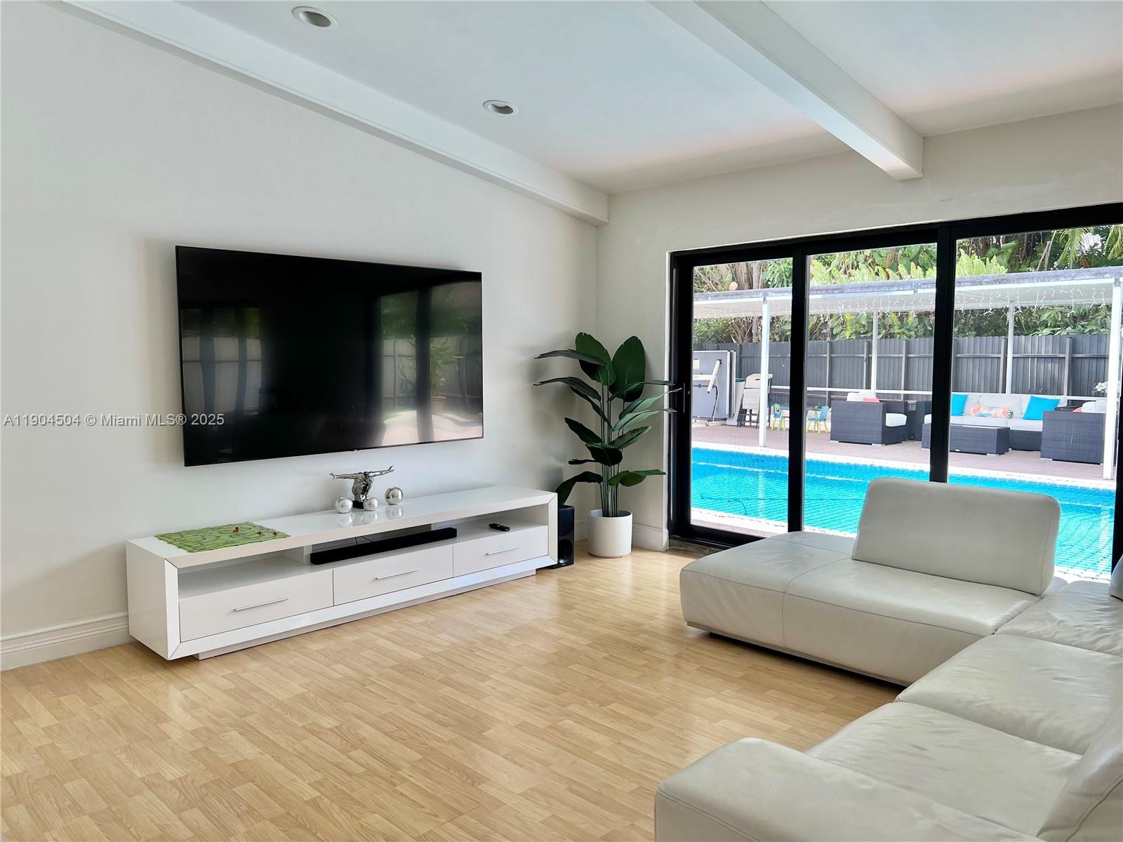 11104 Southwest 139th Court Miami, FL 33186 - Photo 10 of 56 a living room with furniture and a flat screen tv