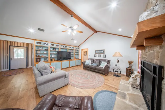 a bedroom with furniture and a large window