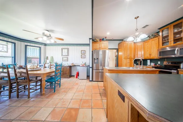 a view of a dining room with furniture and chandelier