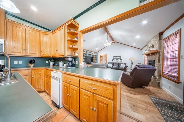 a kitchen with stainless steel appliances granite countertop a sink and cabinets