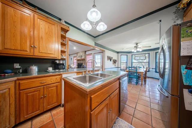 a kitchen with stainless steel appliances granite countertop a sink and cabinets