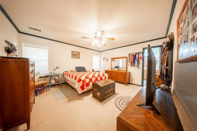 a bedroom with furniture and a mirror