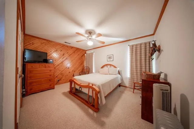 a bedroom with bed and a chandelier