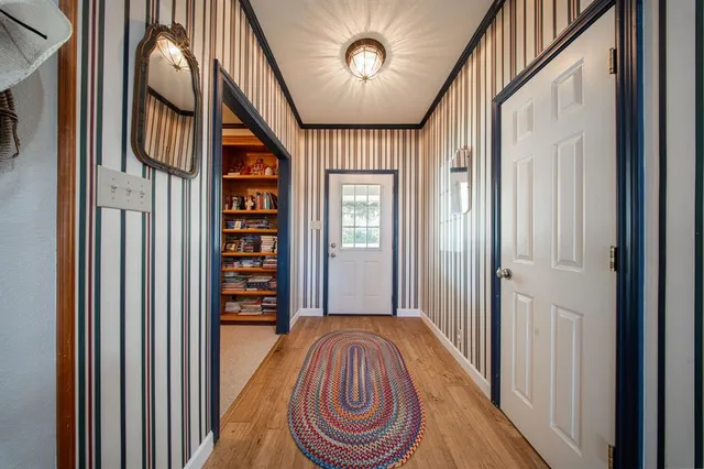 a view of hallway with livingroom and furniture