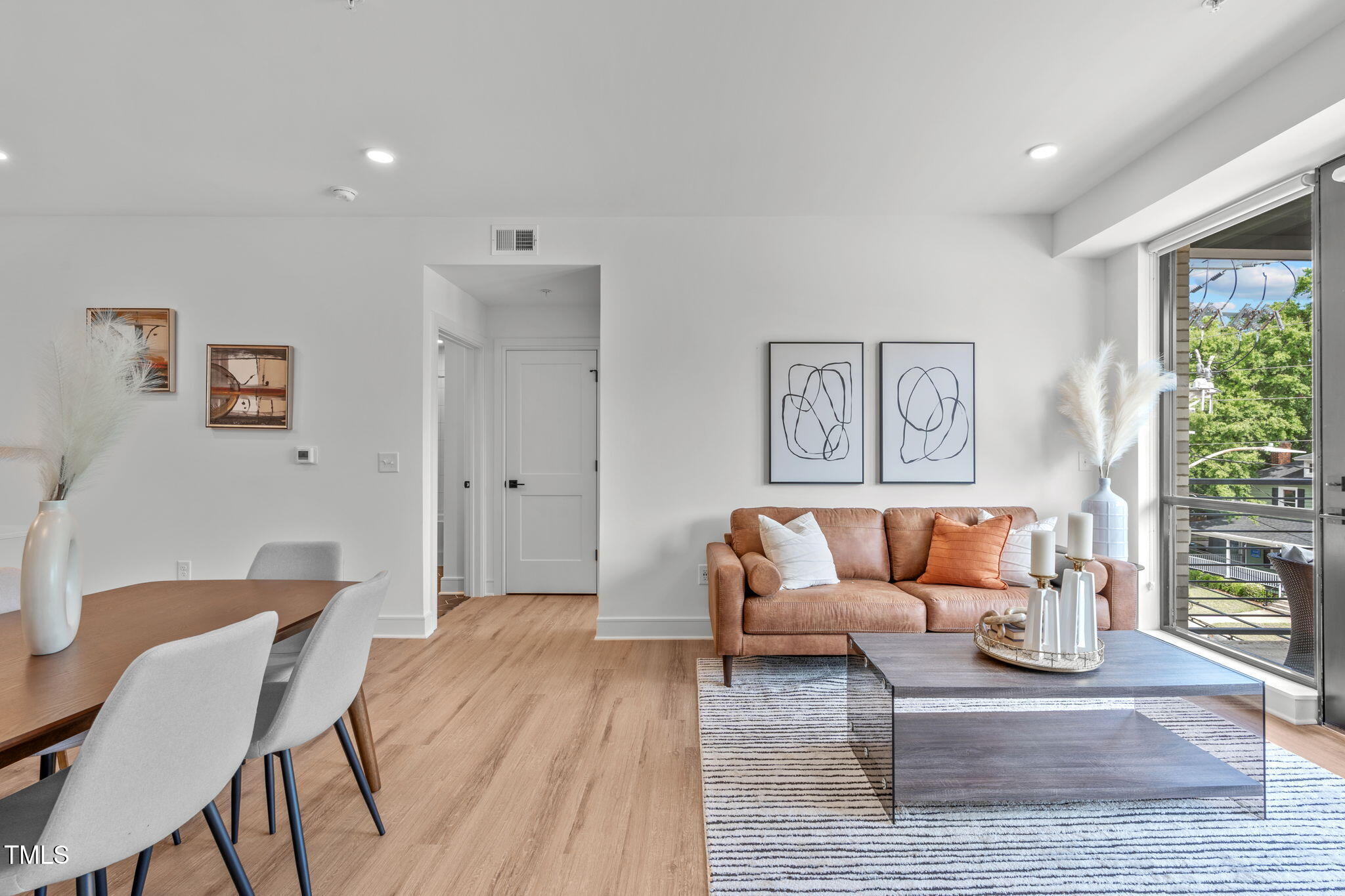 615 West Peace Street, Unit 302 Raleigh, NC 27605 - Photo 19 of 50 a living room with furniture and a wooden floor