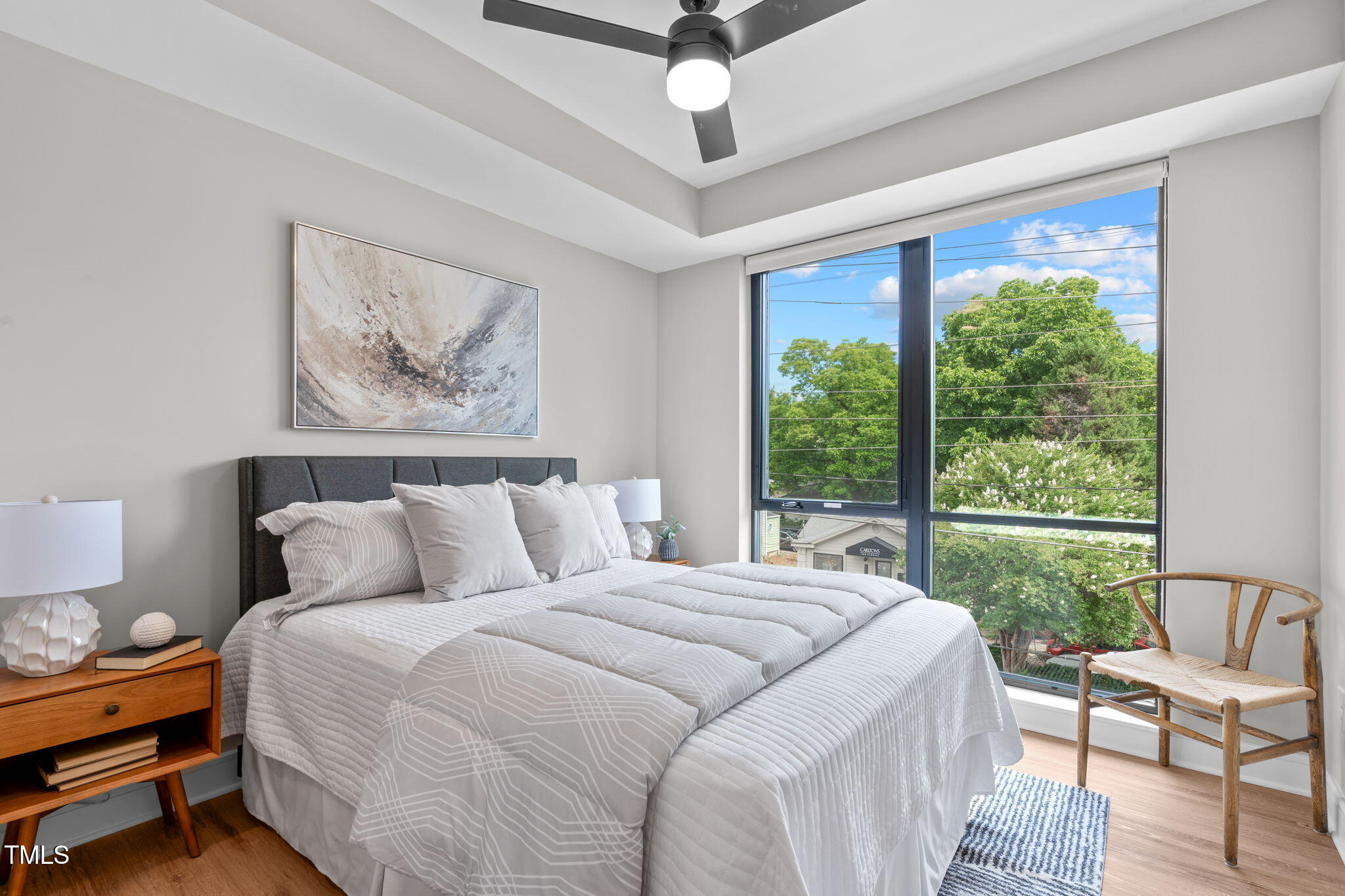 615 West Peace Street, Unit 302 Raleigh, NC 27605 - Photo 20 of 50 a bed sitting in a bedroom next to a window