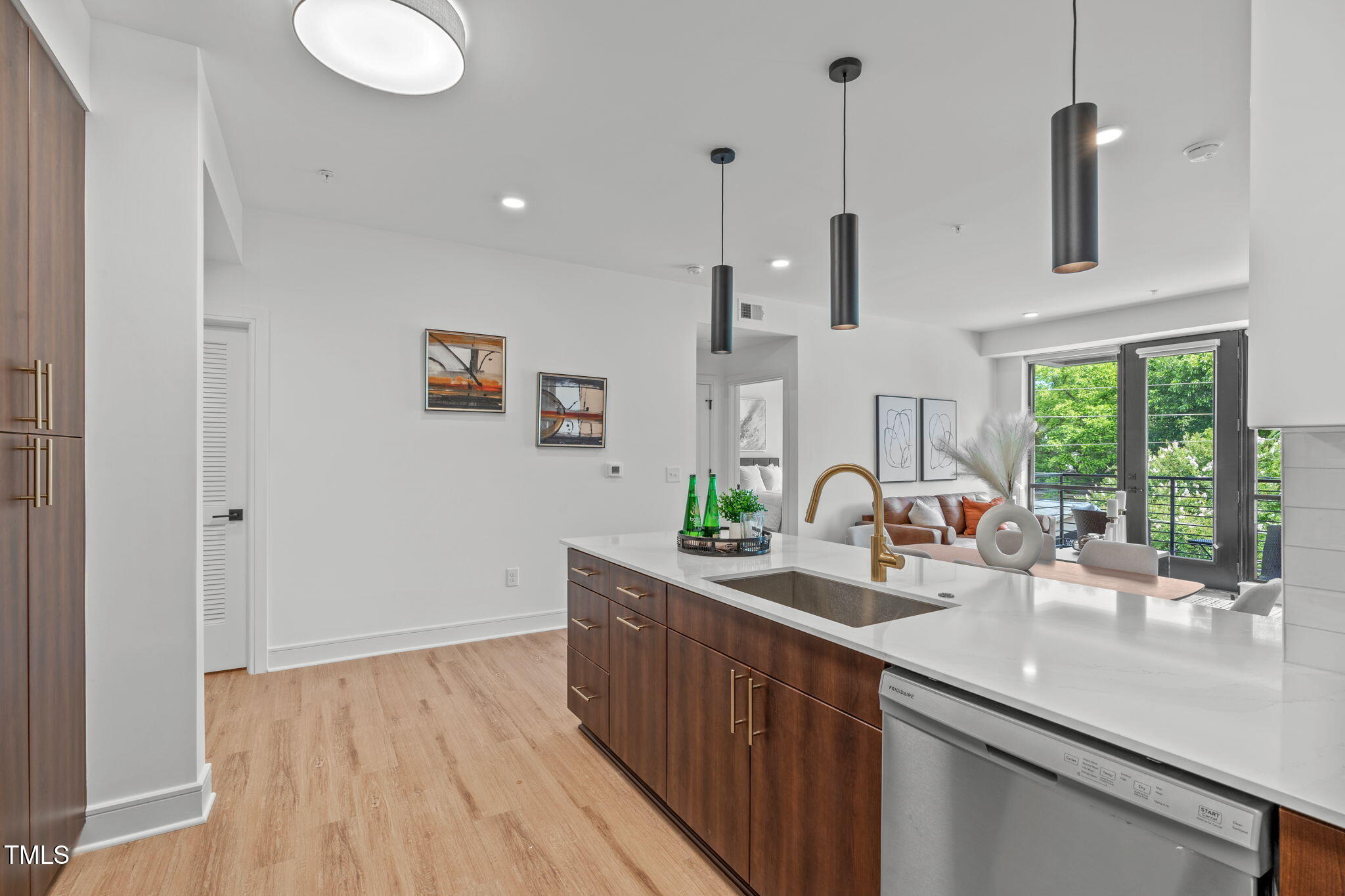 615 West Peace Street, Unit 302 Raleigh, NC 27605 - Photo 6 of 50 a kitchen with stainless steel appliances granite countertop a sink a stove and a wooden floors