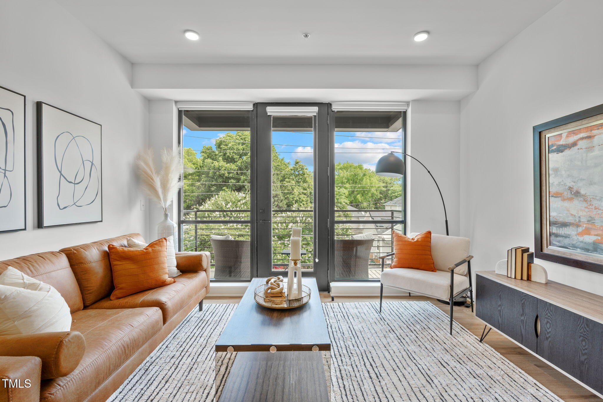 615 West Peace Street, Unit 302 Raleigh, NC 27605 - Photo 8 of 50 a living room with furniture and a large window