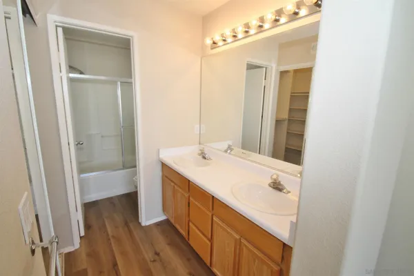 a bathroom with a sink a mirror and a bathtub