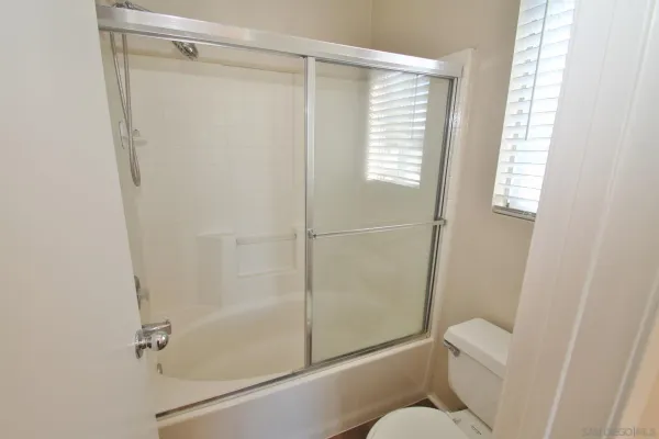 a bathroom with a shower and a toilet