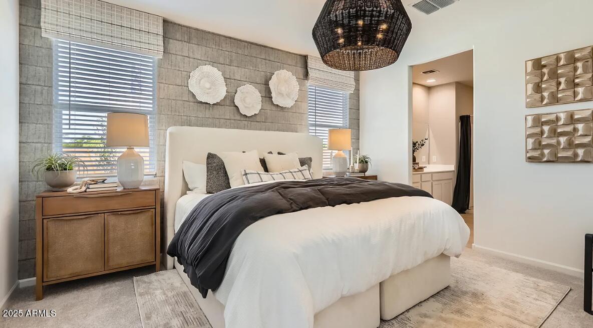 23407 West Bloch Road Buckeye, AZ 85326 - Photo 10 of 22 a bedroom with a bed and a chandelier