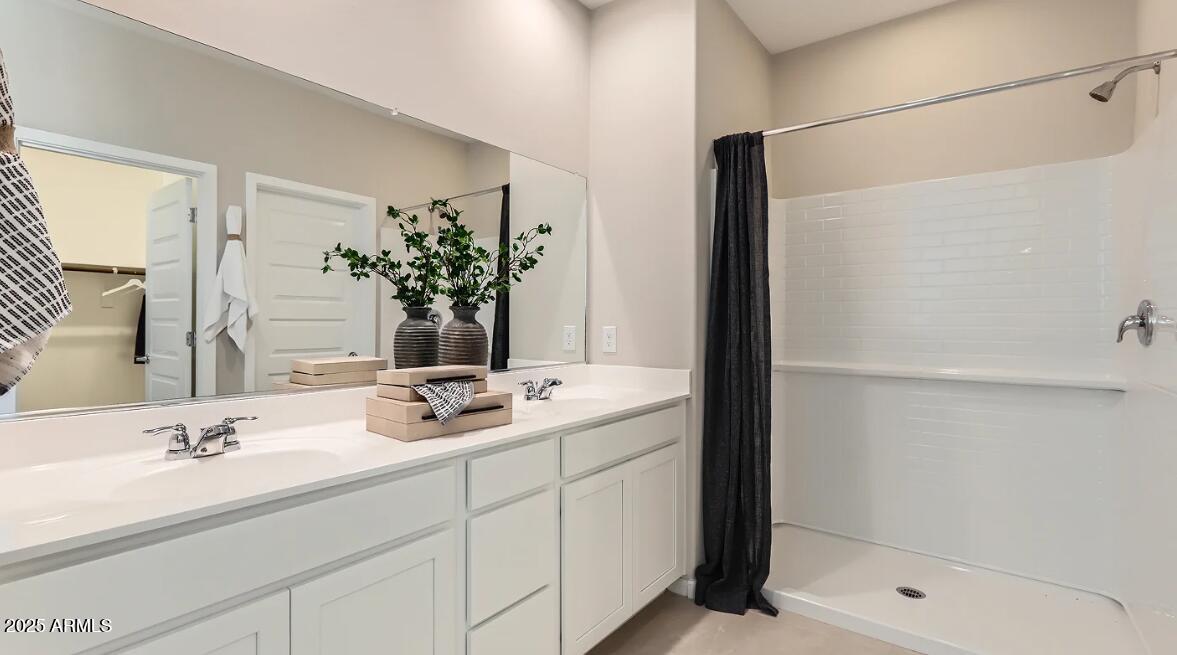 23407 West Bloch Road Buckeye, AZ 85326 - Photo 11 of 22 a bathroom with a shower sink and mirror