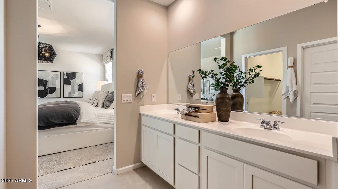 23407 West Bloch Road Buckeye, AZ 85326 - Photo 12 of 22 a en suite bathroom with a granite countertop sink and a mirror