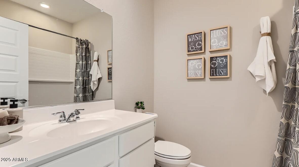 23407 West Bloch Road Buckeye, AZ 85326 - Photo 15 of 22 a bathroom with a sink a toilet and shower