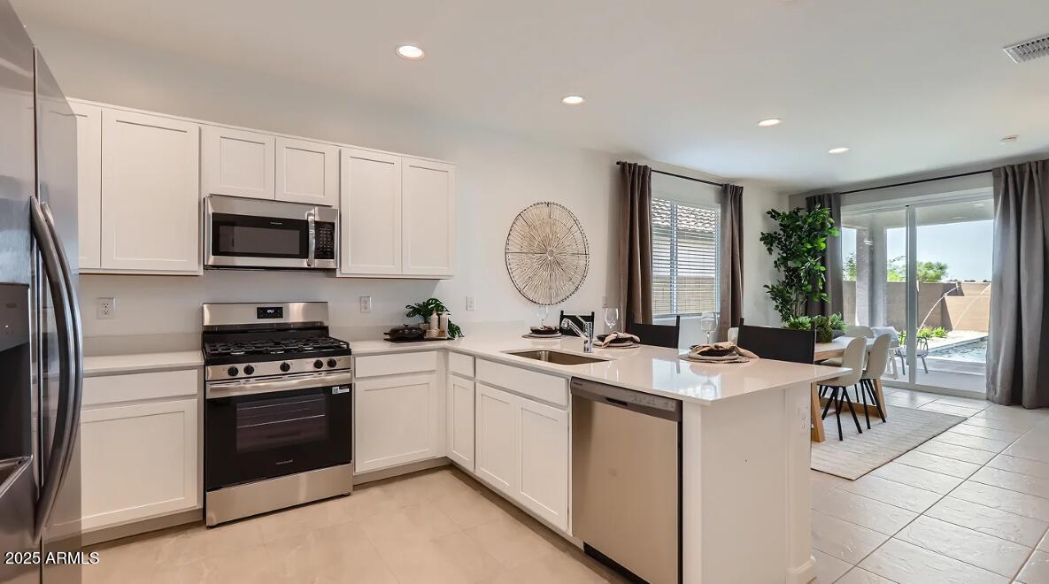 23407 West Bloch Road Buckeye, AZ 85326 - Photo 4 of 22 a kitchen with a sink stove and cabinets