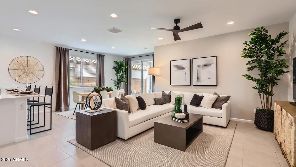 23407 West Bloch Road Buckeye, AZ 85326 - Photo 8 of 22 a living room with furniture a chandelier and a potted plant