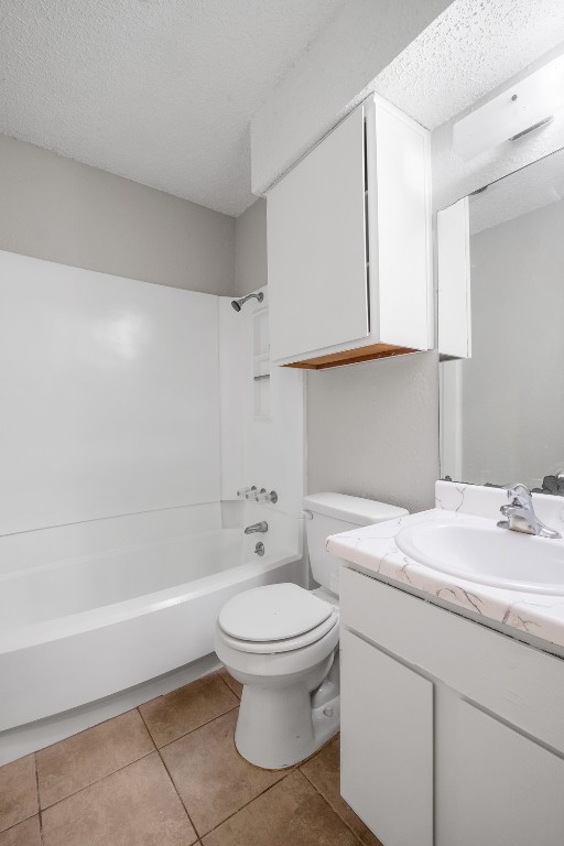 12901 Chromite Street, Unit B Austin, TX 78727 - Photo 8 of 21 Bathroom with shower / bath combination, a textured ceiling, vanity, and light tile patterned flooring