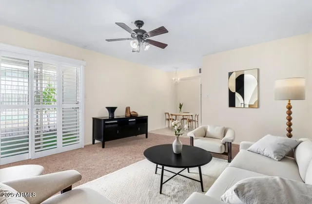 a living room with furniture and a large window