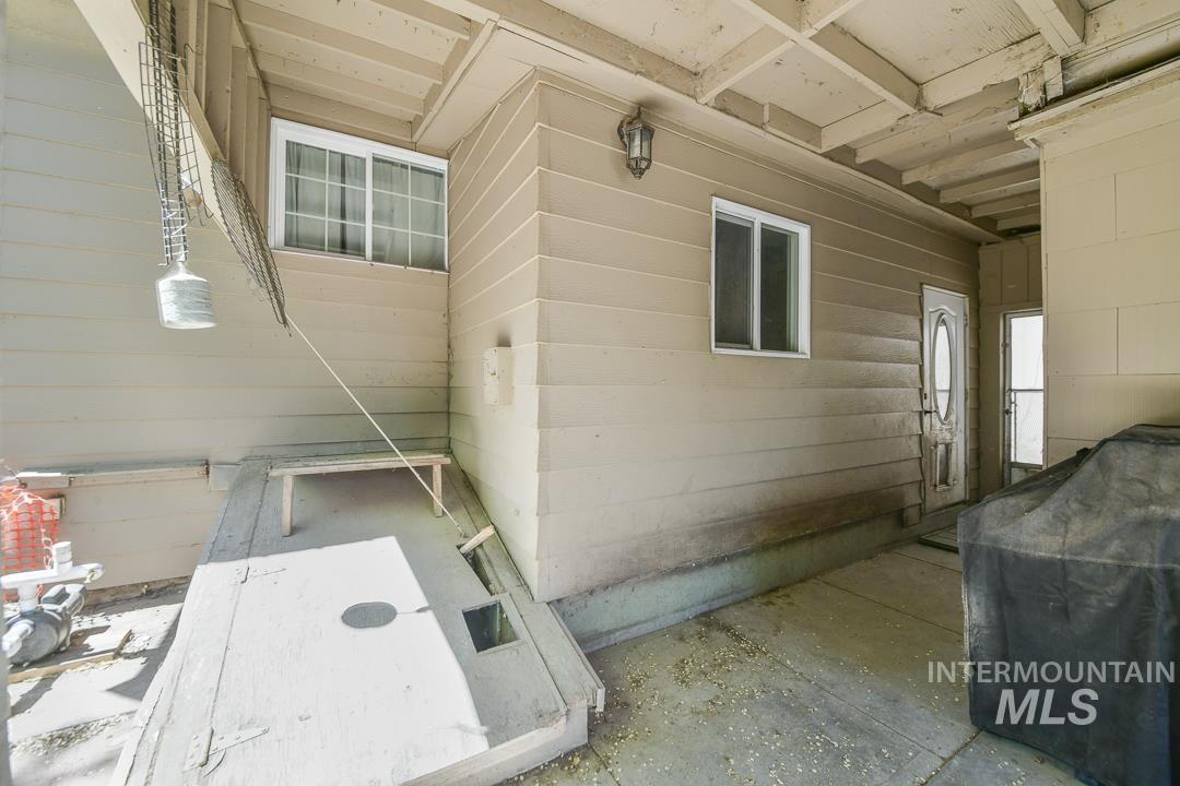486 West Main Street South Vale, OR 97918 - Photo 25 of 37 Covered patio area featuring a concrete surface and exposed ceiling joists