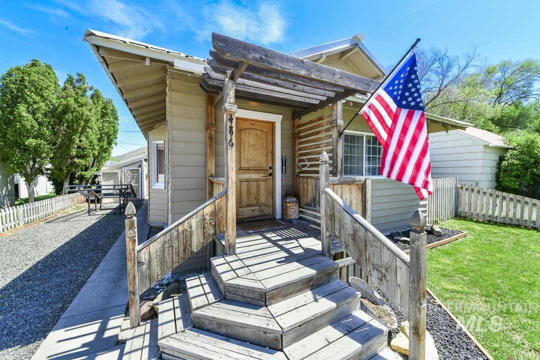 486 West Main Street South Vale, OR 97918 - Photo 4 of 37 Front exterior featuring wood siding, a prominent wooden porch, and a gravel driveway